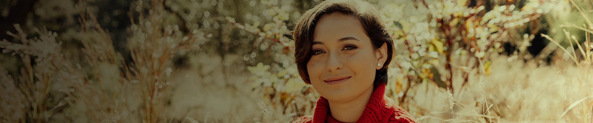 headshot of a woman with short hair on a field